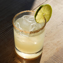 Load image into Gallery viewer, Mad Mexican Classic Margarita in a glass with ice.
