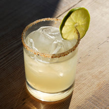 Load image into Gallery viewer, Mad Mexican Classic Margarita in a glass with ice. 
